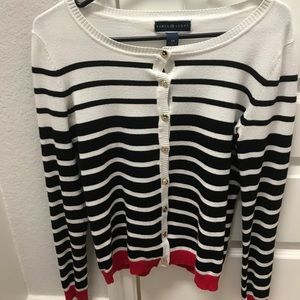 White, black and red long sleeve top.